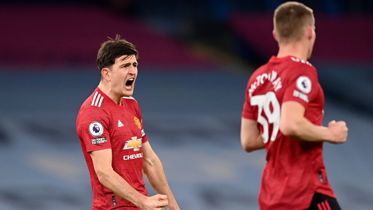 Manchester United's Harry Maguire celebrates at the final whistle during the English Premier League soccer match between Manchester City and Manchester United at the Etihad Stadium in Manchester, England, Sunday, March 7, 2021. (Laurence Griffiths/Pool via AP)