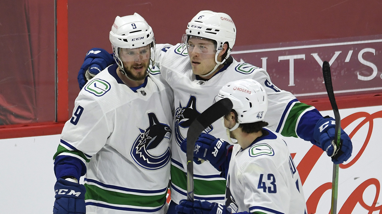 Vancouver Canucks centre J.T. Miller(left) celebrates his game winning goal with team-mates right wing Brock Boeser and defenceman Quinn Hughes during overtime NHL hockey action against the Ottawa Senators, Monday, March 15, 2021. (Adrian Wyld/CP)
