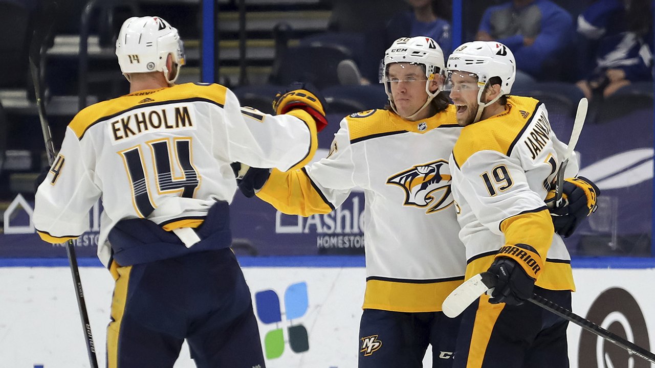 Nashville Predators' Calle Jarnkrok (19), of Sweden, celebrates a goal with Mattias Ekholm (14), also of Sweden, and Erik Haula, of Finland, during the second period of an NHL hockey game against the Tampa Bay Lightning.  (Mike Carlson/AP)