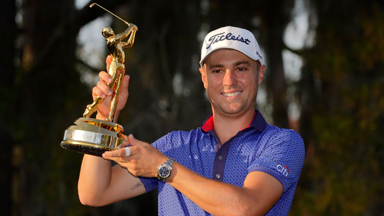 Justin Thomas holds the trophy after winning The Players Championship. (John Raoux/AP)