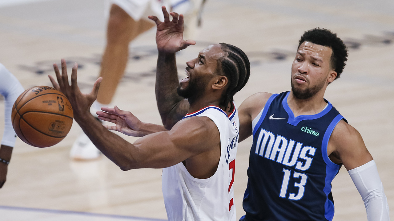 Dallas Mavericks guard Jalen Brunson (13) fouls Los Angeles Clippers forward Kawhi Leonard (2) during the second half of an NBA basketball game, Monday, March 15, 2021, in Dallas. (AP Photo/Brandon Wade)
