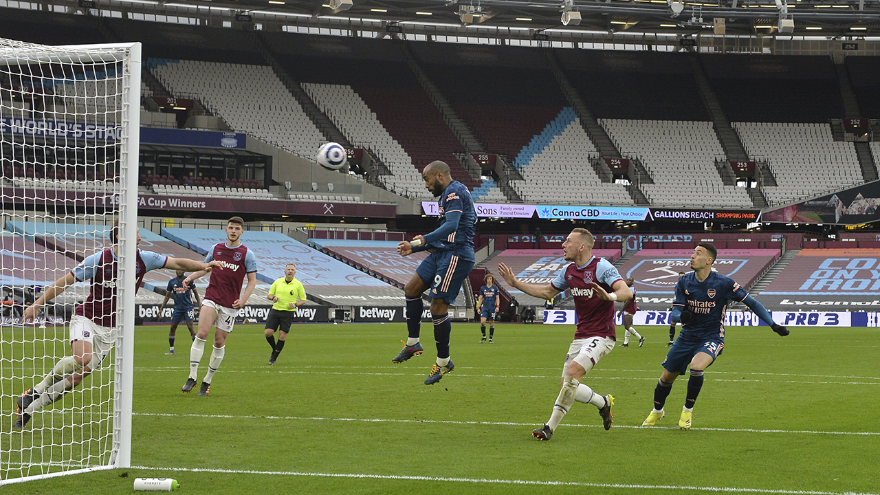 Arsenal's Alexandre Lacazette scores his side's third goal during the English Premier League soccer match between West Ham United and Arsenal. (Justin Tallis, Pool via AP)