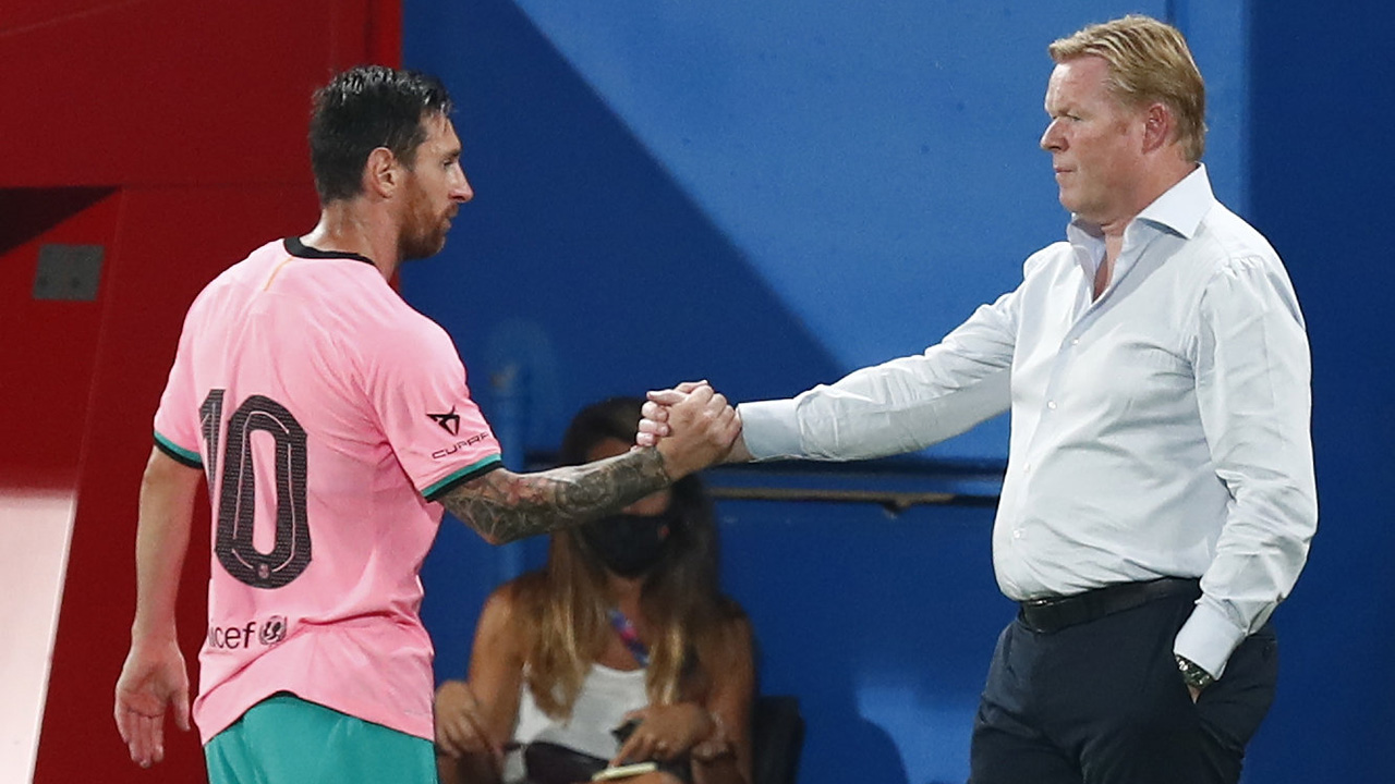 Barcelona's Lionel Messi, left, shakes hands as he is substituted with Barcelona's coach Ronald Koeman as he is substituted. (Joan Monfort/AP)
