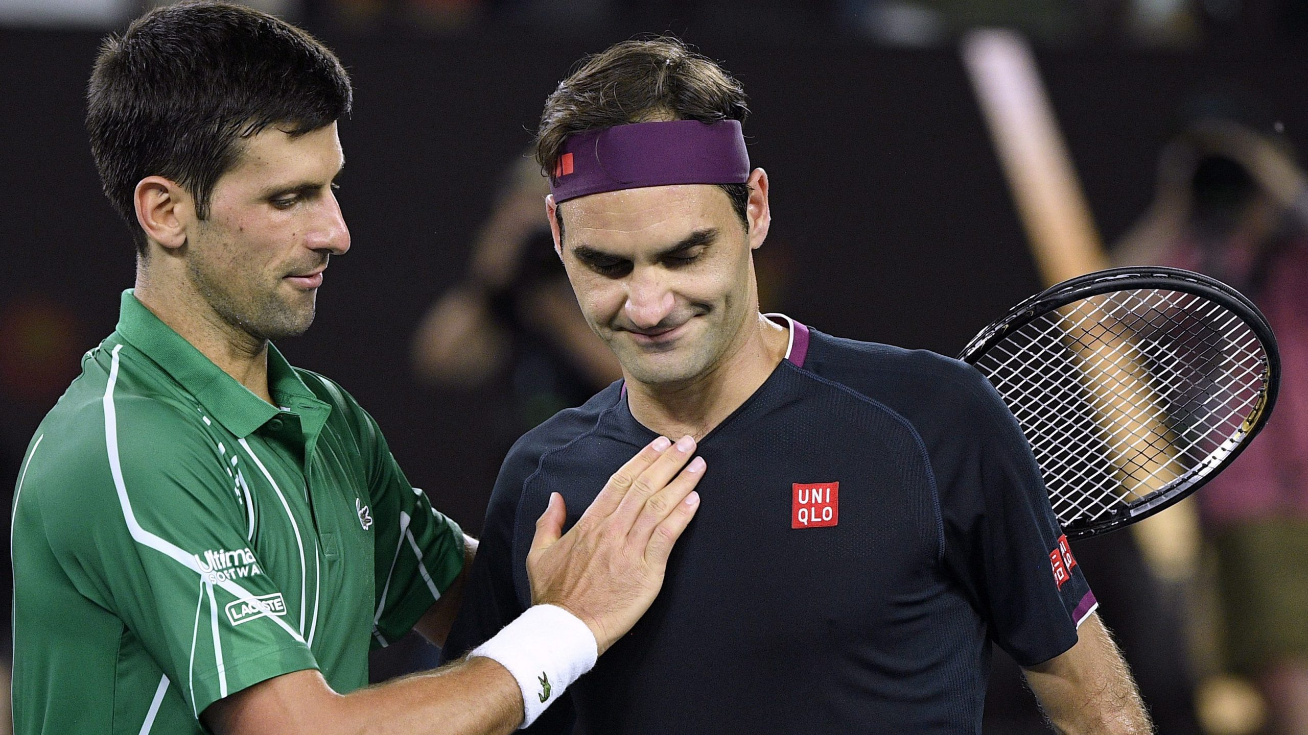 Switzerland's Roger Federer, right, congratulates Serbia's Novak Djokovic on winning their semifinal match at the 2020 Australian Open (Andy Brownbil/AP)