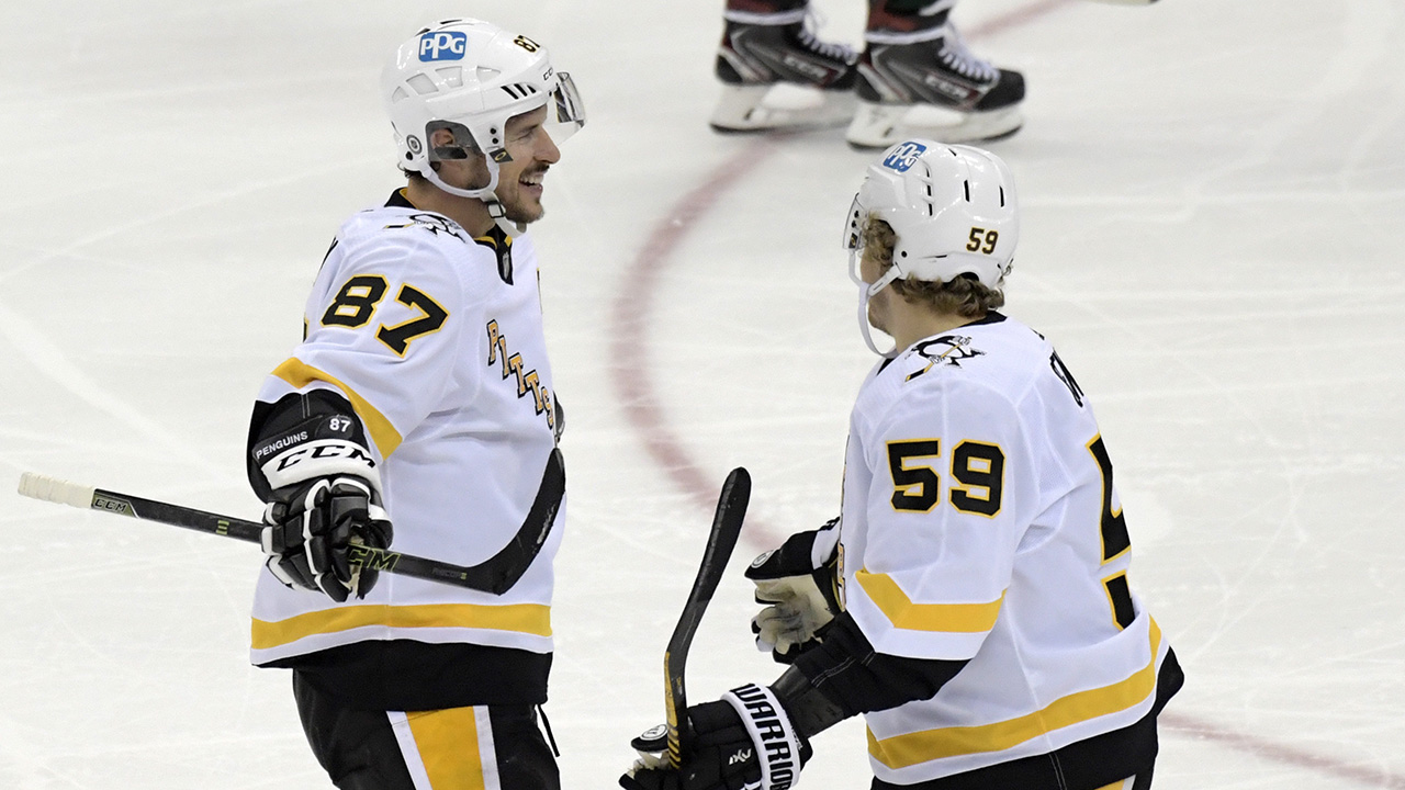 Pittsburgh Penguins left wing Jake Guentzel (59) celebrates his goal with center Sidney Crosby (87) during an NHL hockey game against the New Jersey Devils Saturday, March 20, 2021, in Newark, N.J. (Bill Kostroun/AP)