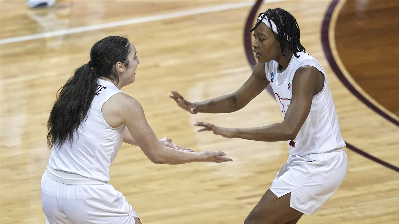 Virginia Tech's Georgia Amoore, left, celebrates with Aisha Sheppard, right, during the second half of a college basketball game against the Marquette. (AP Photo/Chuck Burton)