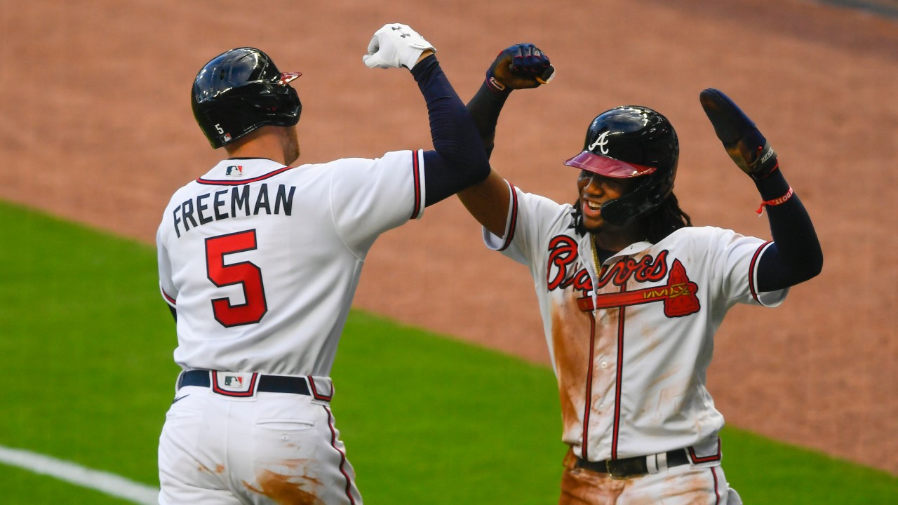 Atlanta Braves' Freddie Freeman (5) celebrates his two-run home run with Ronald Acuña. (AP Photo/John Amis)
