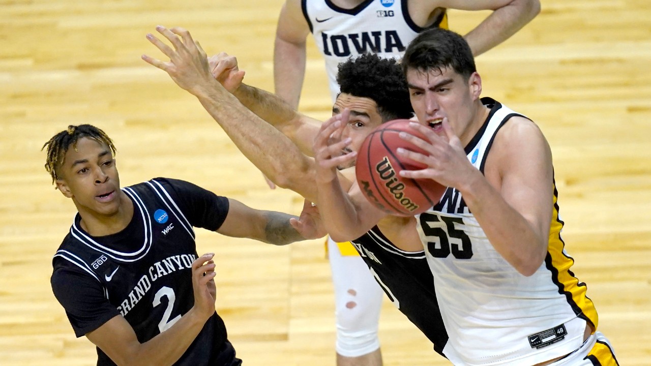 Iowa's Luka Garza (55) bobbles a pass as Grand Canyon's Chance McMillian (2) and Gabe McGlothan defend during the first half of a first round NCAA college basketball tournament game Saturday, March 20, 2021, at the Indiana Farmers Coliseum in Indianapolis. (Charles Rex Arbogast/AP)