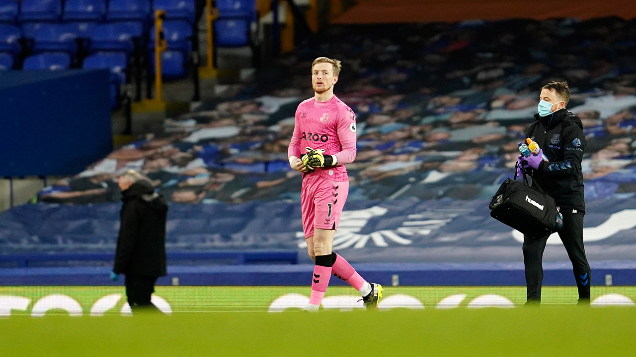 Everton's goalkeeper Jordan Pickford, centre, leaves the field after sustaining an injury during the Premier League match between Everton and Burnley at Goodison Park in Liverpool, England, Saturday, March 13, 2021. (Jon Super/AP)