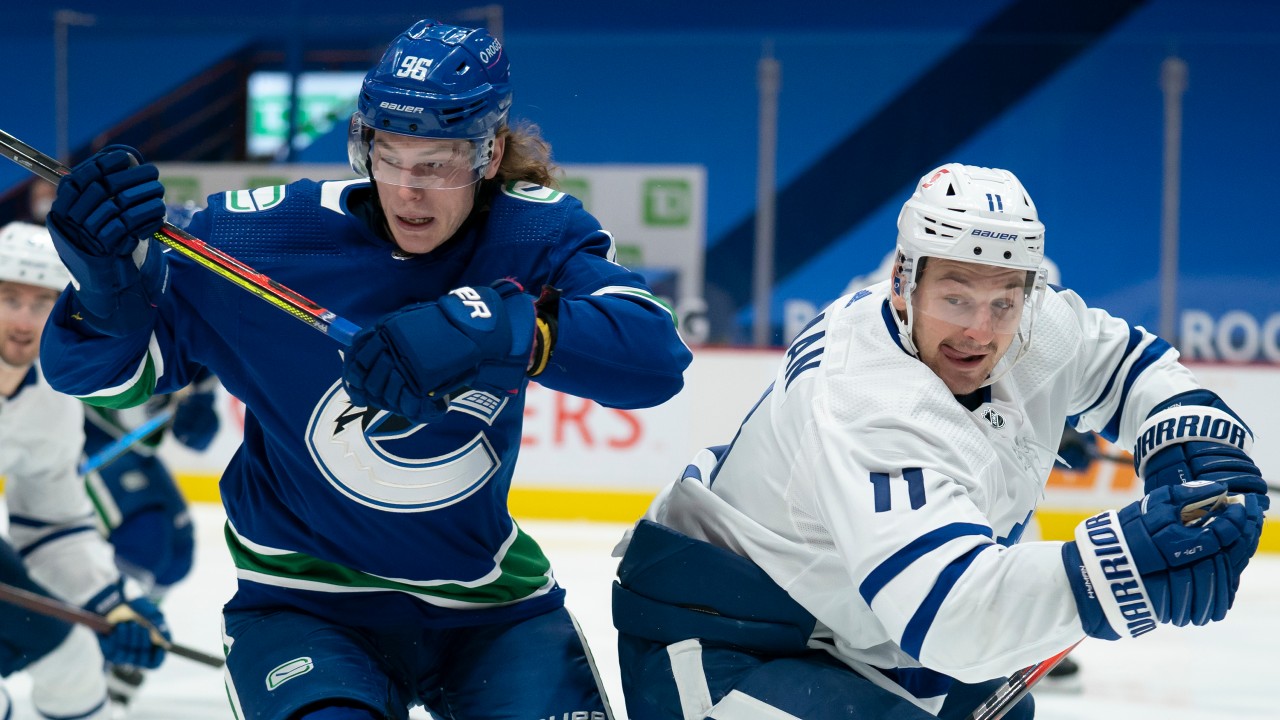Vancouver Canucks centre Adam Gaudette (96) battles with Toronto Maple Leafs left wing Zach Hyman (11) during second period NHL action in Vancouver, Thursday, March 4, 2021. THE CANADIAN PRESS/Jonathan Hayward