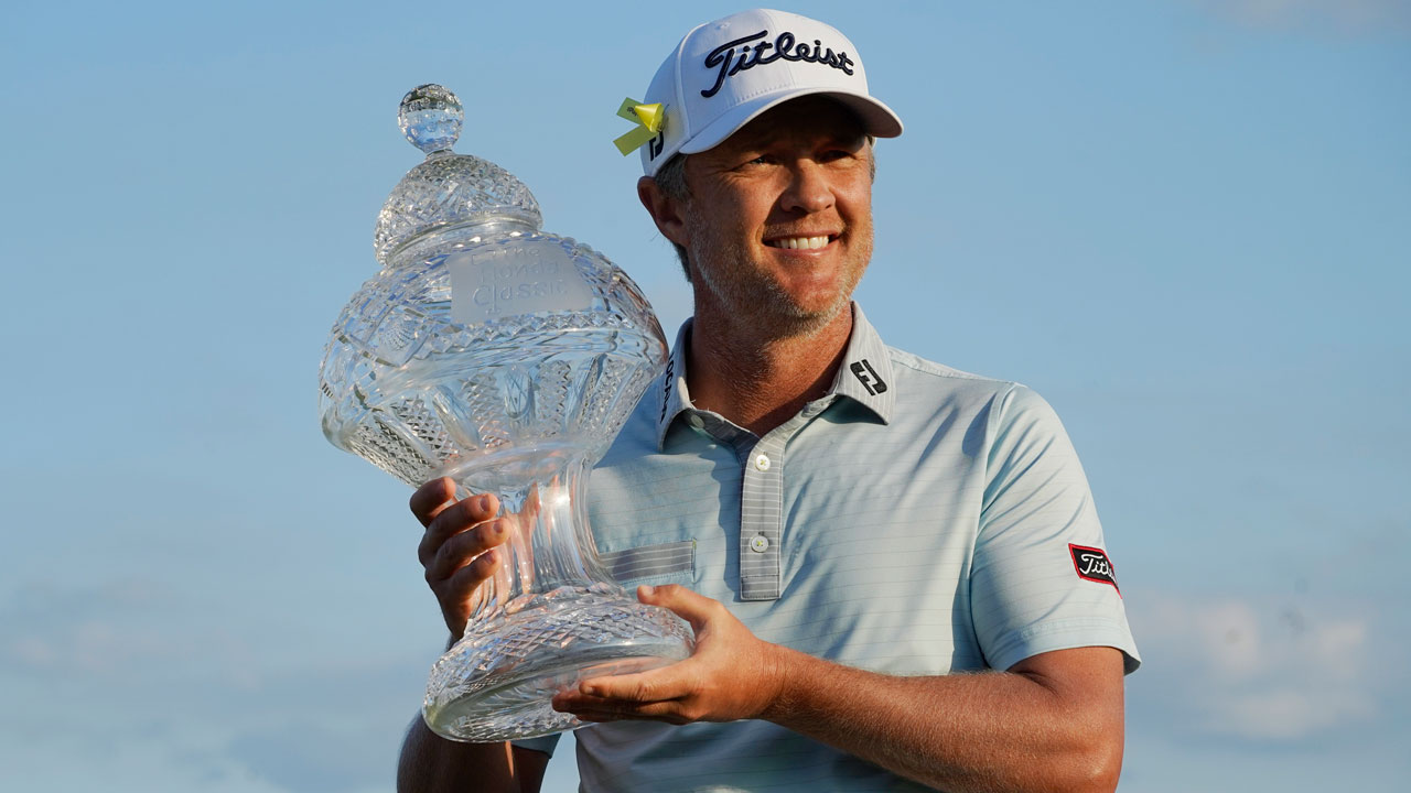 Matt Jones of Australia holds the trophy after winning the Honda Classic golf tournament. (Marta Lavandier/AP)