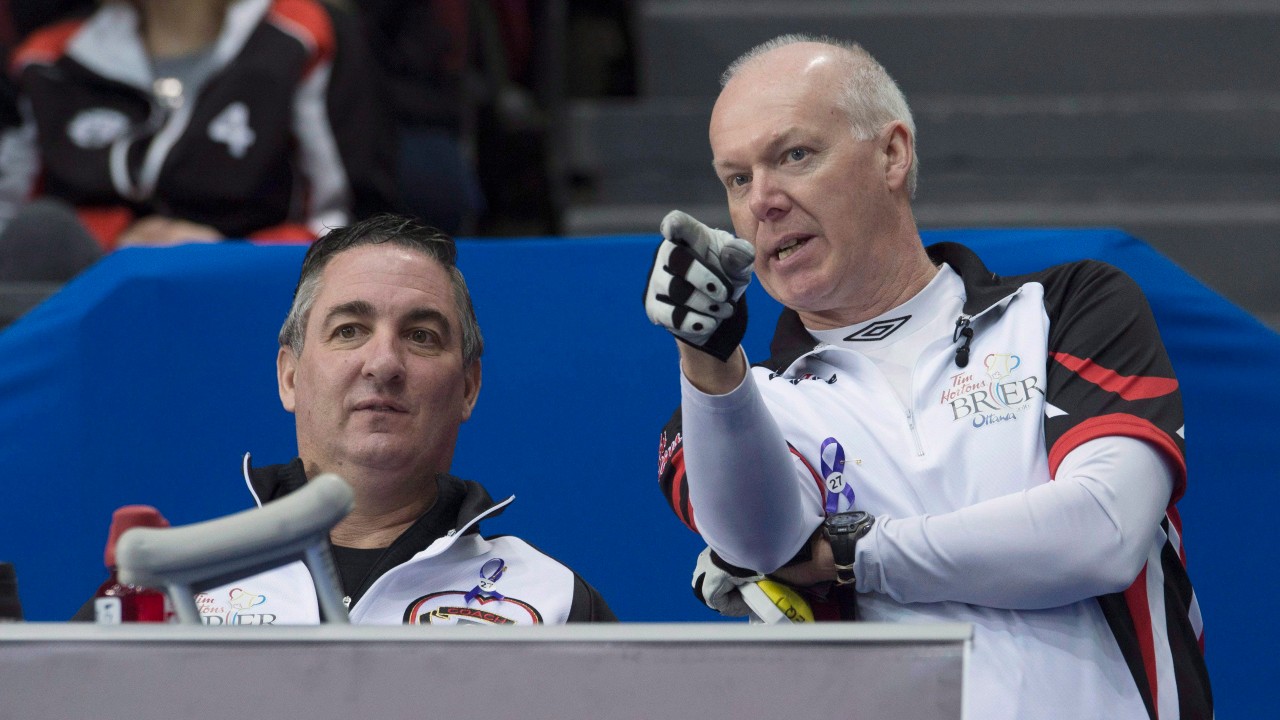 Team Ontario skip Glenn Howard speaks with coach Wayne Middaugh during round robin competition against Team Saskatchewan at the Brier curling championship in Ottawa on Thursday, March 10, 2016. THE CANADIAN PRESS/Adrian Wyld