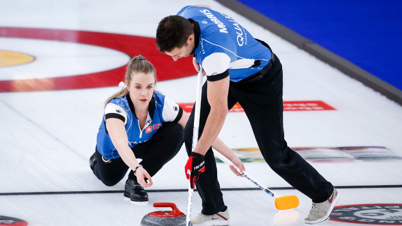Team Schmiemann/Morris skip Danielle Schmiemann makes a shot as third John Morris sweeps while they play Team Walker/Muyres at the Canadian Mixed Doubles Curling Championship in Calgary, Alta., Wednesday, March 24, 2021. (Jeff McIntosh/CP)