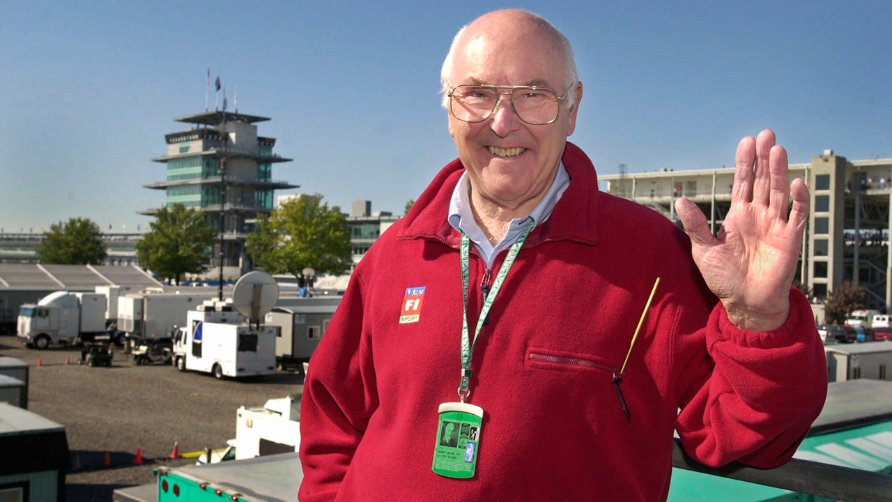 In this Sunday, Sept. 30, 2001 photo, Legendary Formula 1 race broadcaster Murray Walker poses in the television compound at Indianapolis Motor Speedway where he is broadcasting his last race, the United States Grand Prix. (Darron Cummings/AP)