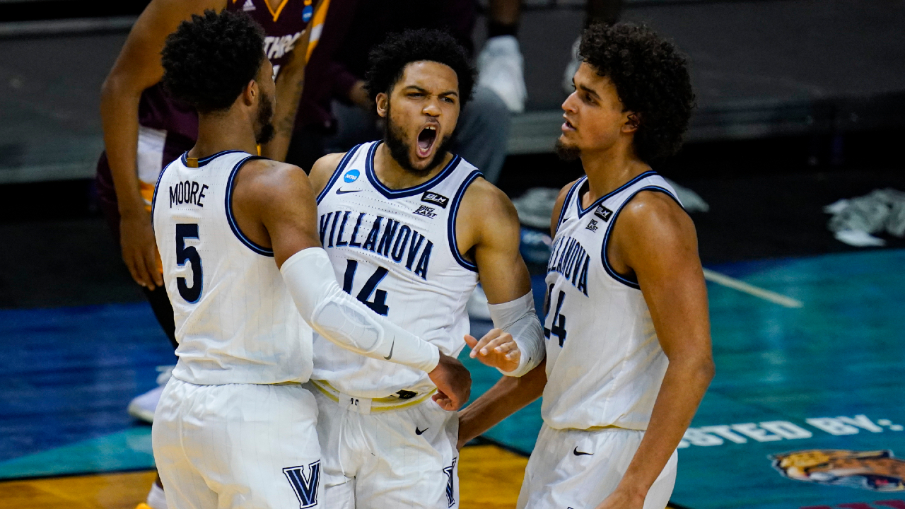 Villanova guard Caleb Daniels (14) celebrates a defensive stop with Justin Moore (5) and Jeremiah Robinson-Earl (24) in the second half of a first round game against Winthrop in the NCAA men's college basketball tournament at Farmers Coliseum in Indianapolis, Friday, March 19, 2021. (Michael Conroy/AP)
