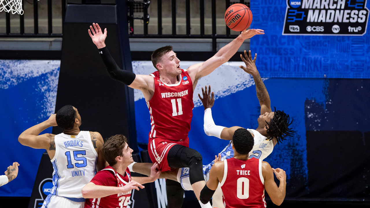 Wisconsin's Micah Potter (11) blocks a shot by North Carolina's Caleb Love (2) during the first half of a first-round game in the NCAA men's college basketball tournament. (Robert Franklin/AP)