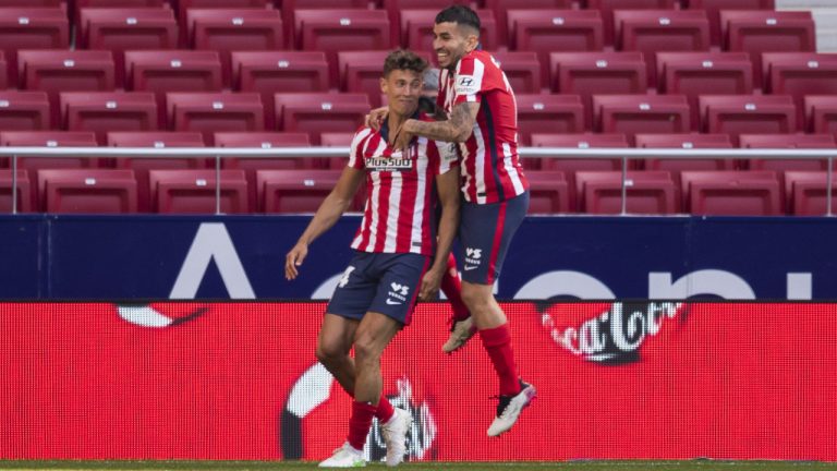 Atletico Madrid's Marcos Llorente, left, is congratulated by Atletico Madrid's Angel Correa after scoring during the Spanish La Liga soccer match between Atletico Madrid and Eibar. (Bernat Armangue/AP)