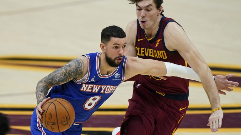 Former New York Knicks Austin Rivers (8) drives past Cleveland Cavaliers' Cedi Osman (16) during the second half of an NBA basketball. (Tony Dejak/AP)