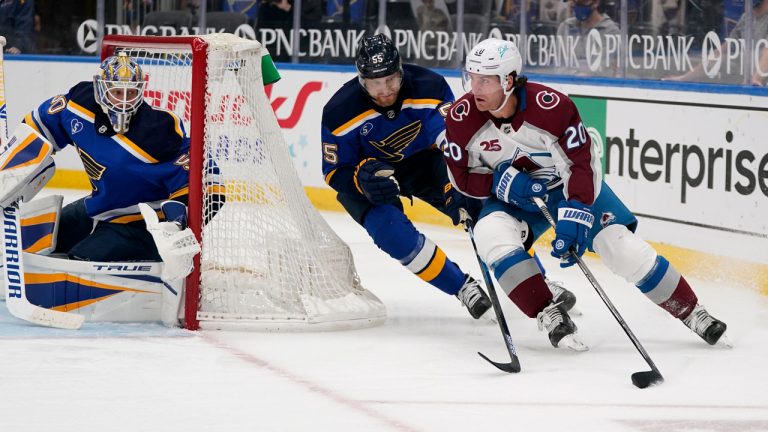 Colorado Avalanche winger Brandon Saad, right, handles the puck as St. Louis Blues goaltender Jordan Binnington, left, and defenceman Colton Parayko (55) defend. (Jeff Roberson/AP)