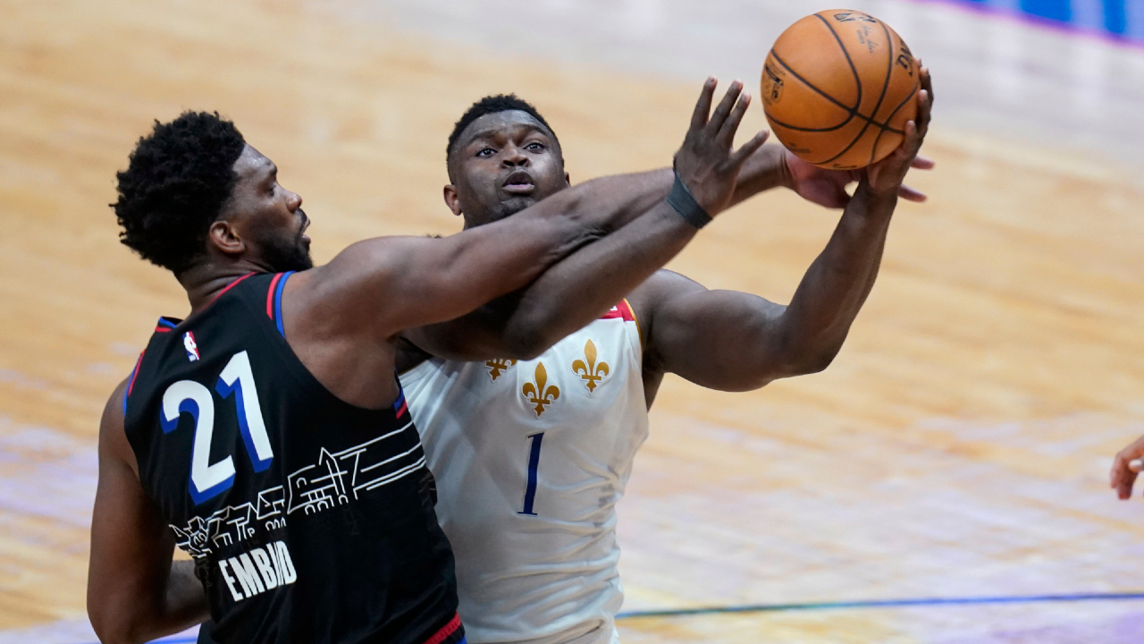 New Orleans Pelicans forward Zion Williamson (1) is fouled as he goes to the basket against Philadelphia 76ers center Joel Embiid (21) in the second half of an NBA basketball game in New Orleans, Friday, April 9, 2021. (AP Photo/Gerald Herbert)