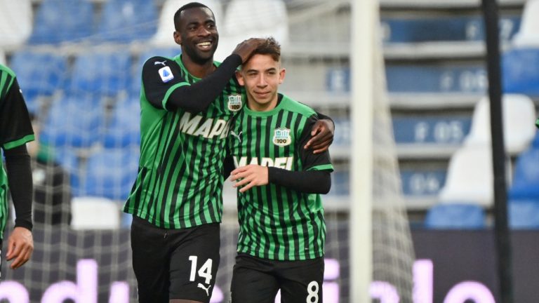 Sassuolo's Maxime Lopez, right, is hugged by teammate Pedro Obiang after scoring during the Italian Serie A soccer match between Sassuolo and Fiorentina at the Mapei Città del Tricolore Stadium, Reggio Emilia, Saturday, April 17, 2021. (Massimo Paolone/LaPresse via AP)