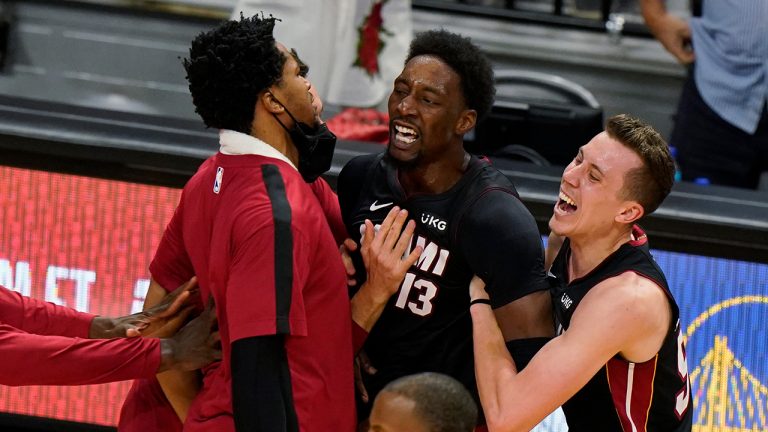 Miami Heat center Bam Adebayo (13) is mobbed by teammates after he made the winning shot against the Brooklyn Nets at the end of an NBA basketball game, Sunday, April 18, 2021, in Miami. (Wilfredo Lee/AP)