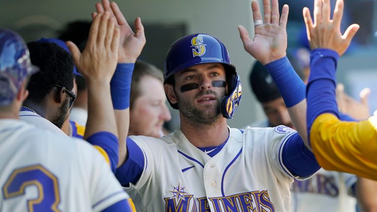 Seattle Mariners' Mitch Haniger is greeted in the dugout after he scored on a home run hit by Ty France during the fifth inning of a baseball game against the Houston Astros, Sunday, April 18, 2021, in Seattle. (Ted S. Warren/AP)