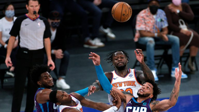 Charlotte Hornets' Jalen McDaniels and Miles Bridges (0) work against New York Knicks' RJ Barrett and Julius Randle (30) for the ball during the first half of an NBA basketball game Tuesday, April 20, 2021, in New York. (Sarah Stier/Pool Photo via AP)