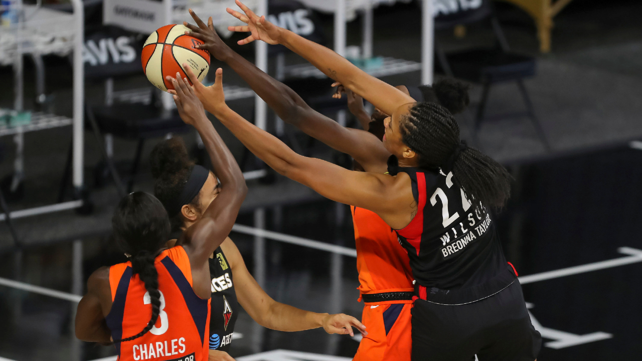 Las Vegas Aces' A'ja Wilson (22) and Connecticut Sun's Kaila Charles (3) reach for a rebound during the first half of a WNBA basketball game Thursday, Aug. 20, 2020, in Bradenton, Fla. (AP Photo/Mike Carlson)