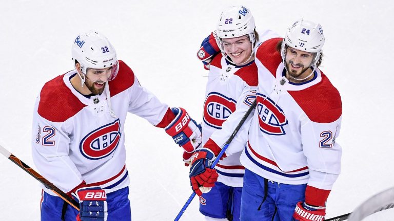 Montreal Canadiens rookie Cole Caufield, centre, is seen celebrating with teammates Erik Gustafsson and Phillip Danault in his NHL debut on April 26, 2021. (Montreal Canadiens / Twitter)