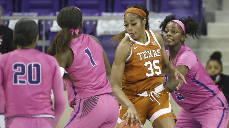 Texas forward Charli Collier (35) handles the ball as TCU forward Yummy Morris (5), TCU guard Aahliyah Jackson (1), and TCU guard Lauren Heard (20) defend during the first half of an NCAA college basketball game. (Ron Jenkins/AP)