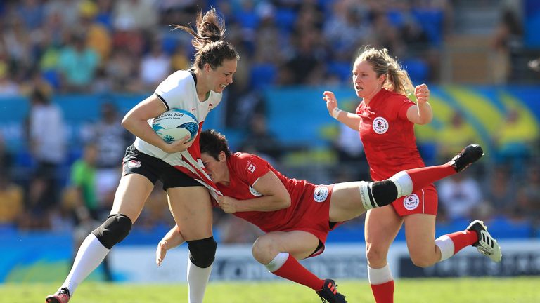 Canada's Brittany Benn (centre) tackles England's Emily Scarratt (left) the Women's Rugby Sevens bronze medal match at the Robina Stadium during day eleven of the 2018 Commonwealth Games in the Gold Coast, Australia.