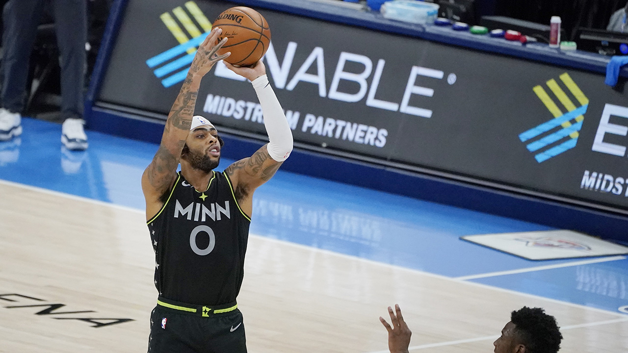Minnesota Timberwolves guard D'Angelo Russell (0) shoots a three-point basket over Oklahoma City Thunder guard Hamidou Diallo, right, in the final seconds of an NBA basketball game. (Sue Ogrocki/AP)