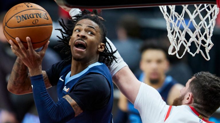 Memphis Grizzlies guard Ja Morant, left, shoots over Portland Trail Blazers center Jusuf Nurkic during the second half of an NBA basketball game in Portland, Ore., Sunday, April 25, 2021. (Craig Mitchelldyer /AP)