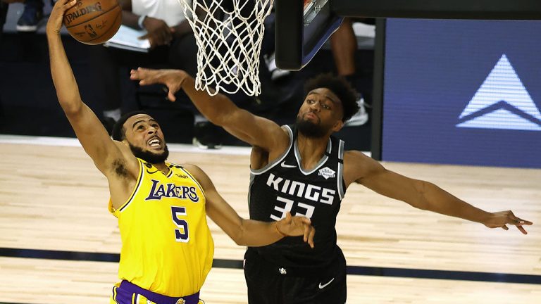 Los Angeles Lakers' Talen Horton-Tucker (5) goes up for a slam dunk against Sacramento Kings' Jabari Parker (33) during the third quarter of an NBA basketball game Thursday, Aug. 13, 2020, in Lake Buena Vista, Fla. (Kevin C. Cox/AP)