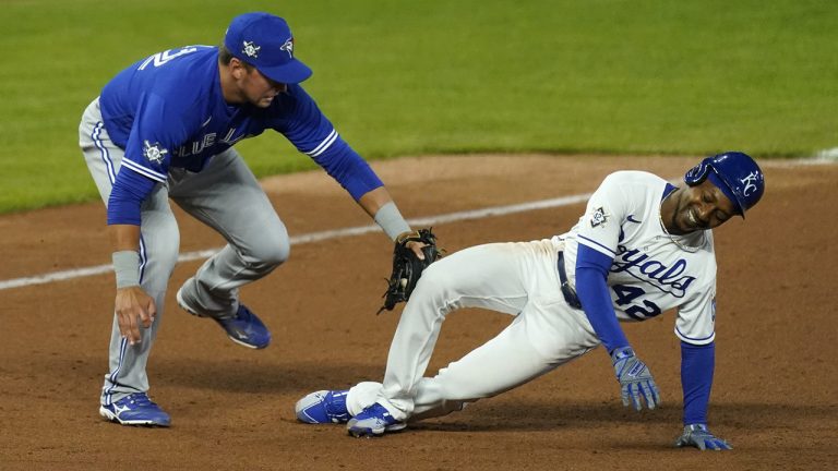 Kansas City Royals' Jarrod Dyson, right, is tagged out by Toronto Blue Jays third baseman Joe Panik while trying to reach third on a single by Hunter Dozier during the eighth inning of a baseball game Thursday, April 15, 2021, in Kansas City, Mo. (Charlie Riedel/AP)
