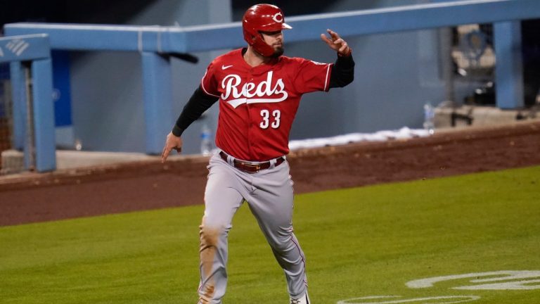 Cincinnati Reds' Jesse Winker (33) runs home to score off of a double hit by Joey Votto during the seventh inning of a baseball game against the Los Angeles Dodgers Tuesday, April 27, 2021, in Los Angeles. Nick Castellanos also scored. (Ashley Landis / AP)