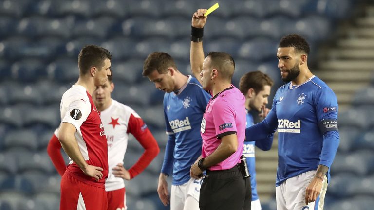 Slavia Prague's Ondrej Kudela, left, receives a yellow card during the UEFA Europa League Round of Sixteen soccer match at Ibrox Stadium, Glasgow. (Andrew Milligan/PA via AP)