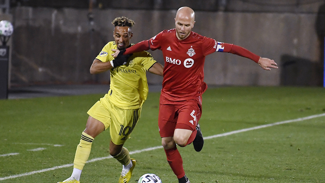 Nashville SC's Hany Mukhtar, left, and Toronto FC's Michael Bradley vie for control of the ball during the first half of an MLS soccer playoff match. (Jessica Hill/AP)