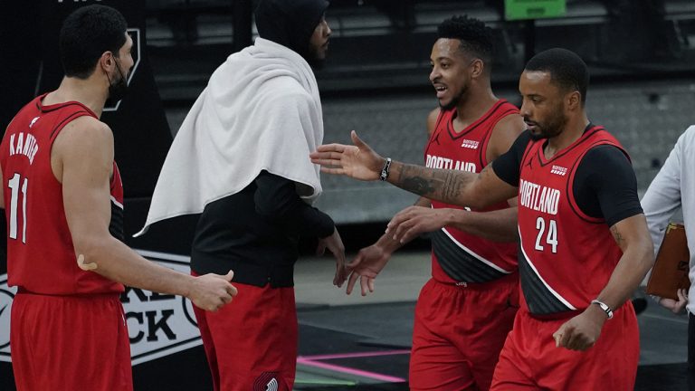Portland Trail Blazers forward Norman Powell (24) and guard CJ McCollum, second from right, celebrate their win against the San Antonio Spurs with teammates Enes Kanter (11) and Carmelo Anthony, second from left, during the second half of an NBA basketball game. (Eric Gay/AP)