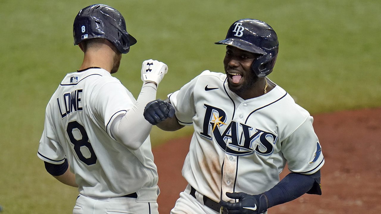 Tampa Bay Rays' Randy Arozarena celebrates his solo home run off New York Yankees starting pitcher Domingo German with second baseman Brandon Lowe. (Chris O'Meara/AP)