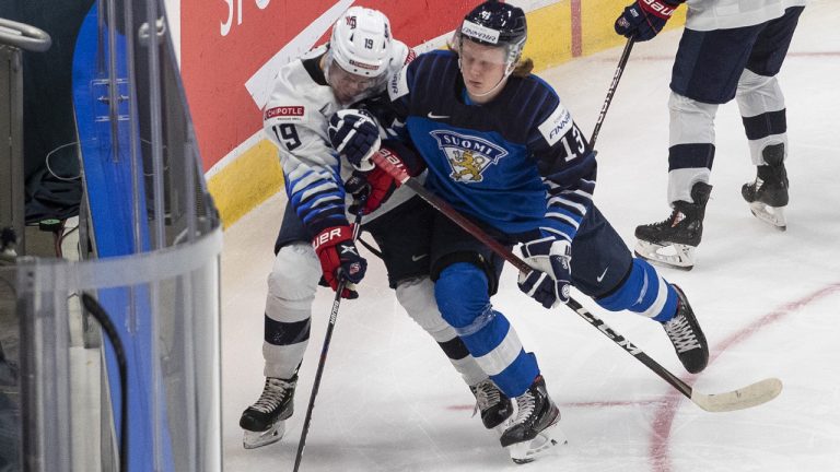 United States' Patrick Moynihan (19) is checked by Finland's Roby Jarventie (13) during second period IIHF World Junior Hockey Championship. (Jason Franson/CP)