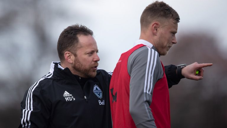 Vancouver Whitecaps head coach Marc Dos Santos, left, speaks to defender and midfielder Andy Rose during the MLS soccer team's training camp in Vancouver. (Darryl Dyck/CP)
