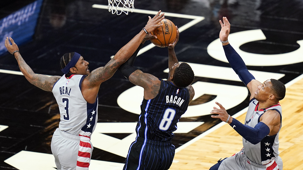 Washington Wizards guard Bradley Beal (3) and guard Russell Westbrook, right, stop Orlando Magic guard Dwayne Bacon (8) from making a shot during the first half of an NBA basketball game. (John Raoux/AP)