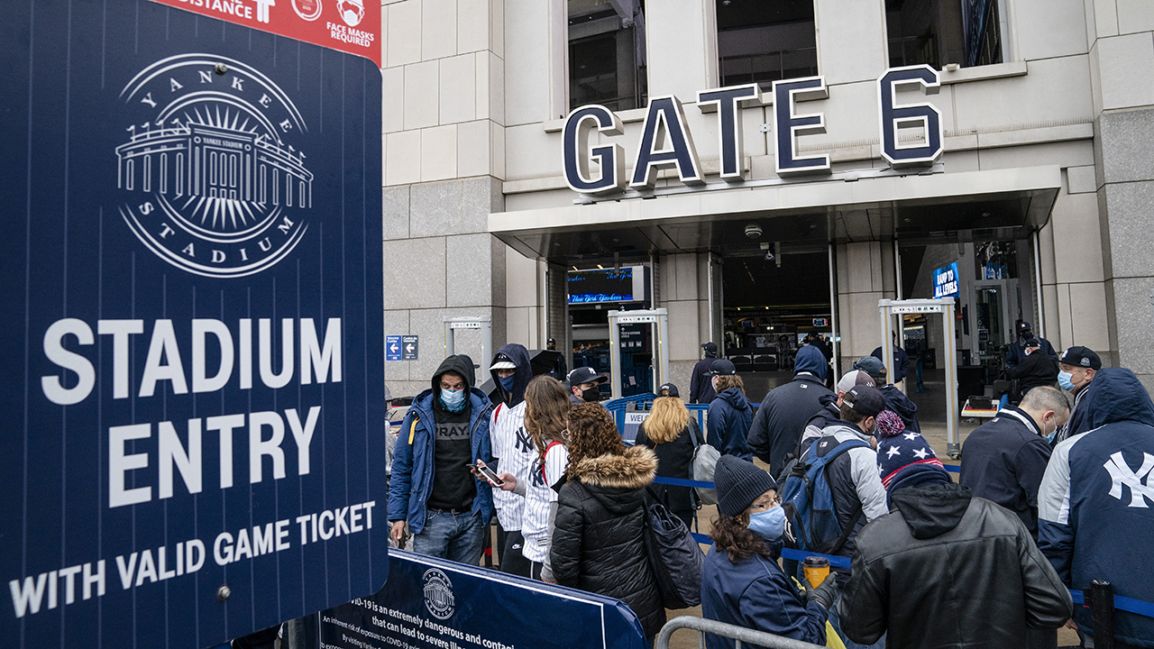 Spectators wait on a security line outside Yankee Stadium before an opening day baseball game against the Toronto Blue Jays, Thursday, April 1, 2021, in the Bronx. (John Minchillo/AP)