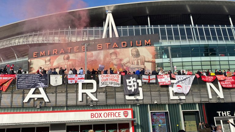 Fans protest outside the Emirates Stadium before the club's Premier League match against Everton. (Frank Giffiths/AP)