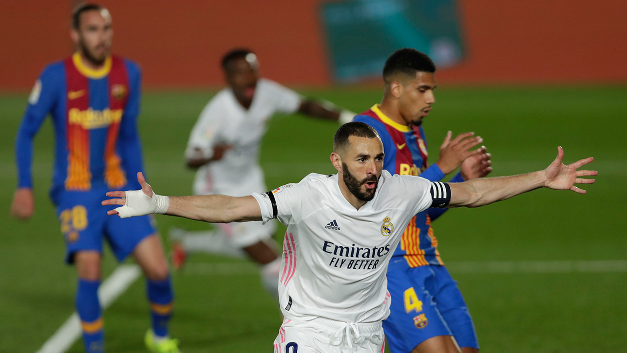 Real Madrid's Karim Benzema celebrates after scoring the opening goal during the Spanish La Liga soccer match between Real Madrid and FC Barcelona at the Alfredo di Stefano stadium in Madrid, Spain, Saturday, April 10, 2021. (Manu Fernandez/AP)