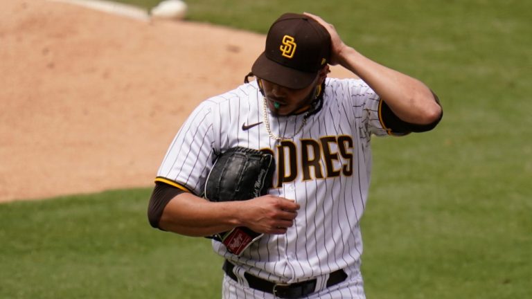 San Diego Padres starting pitcher Dinelson Lamet walks towards the dugout after the third out during the first inning of a baseball game against the Milwaukee Brewers, Wednesday, April 21, 2021, in San Diego. (AP Photo/Gregory Bull)