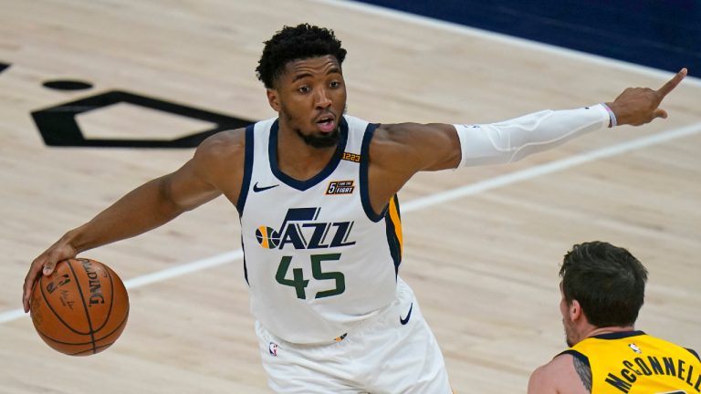 Utah Jazz guard Donovan Mitchell (45) brings the ball up court as Indiana Pacers guard T.J. McConnell defends in the first half during an NBA basketball game Friday, April 16, 2021, in Salt Lake City. (Rick Bowmer/AP)
