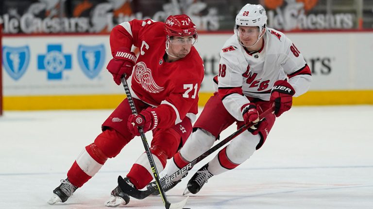 Detroit Red Wings centre Dylan Larkin (71) skates with the puck as Carolina Hurricanes centre Martin Necas (88) defends in the second period on Tuesday, March 16, 2021, in Detroit. (Paul Sancya/AP)